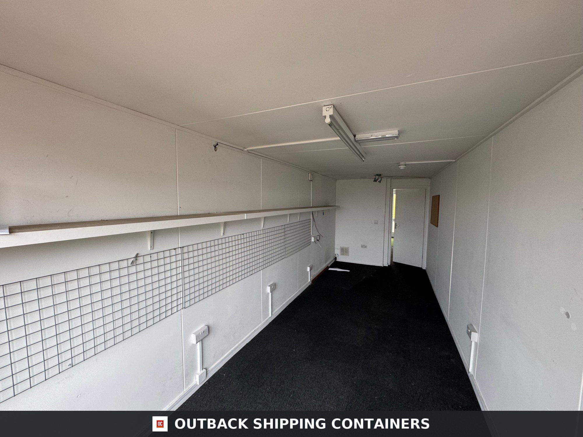 40 Ft Converted Shipping Container 40FT for Sale — Roof and Structural Detail 40ft office container interior with white walls black flooring wire grid organizers and overhead shelving