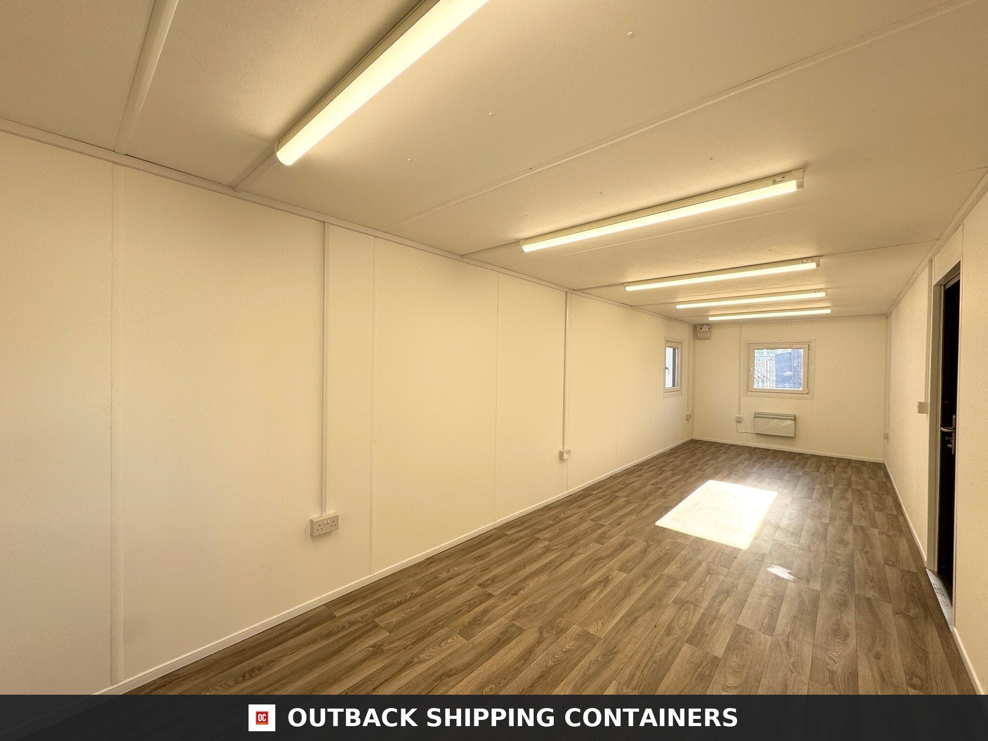 32x10ft Cabin for Sale — Window and Shutter Detail | Outback Shipping Containers Exterior view of a charcoal gray 32ft anti-vandal portable office cabin with steel door and window shutters