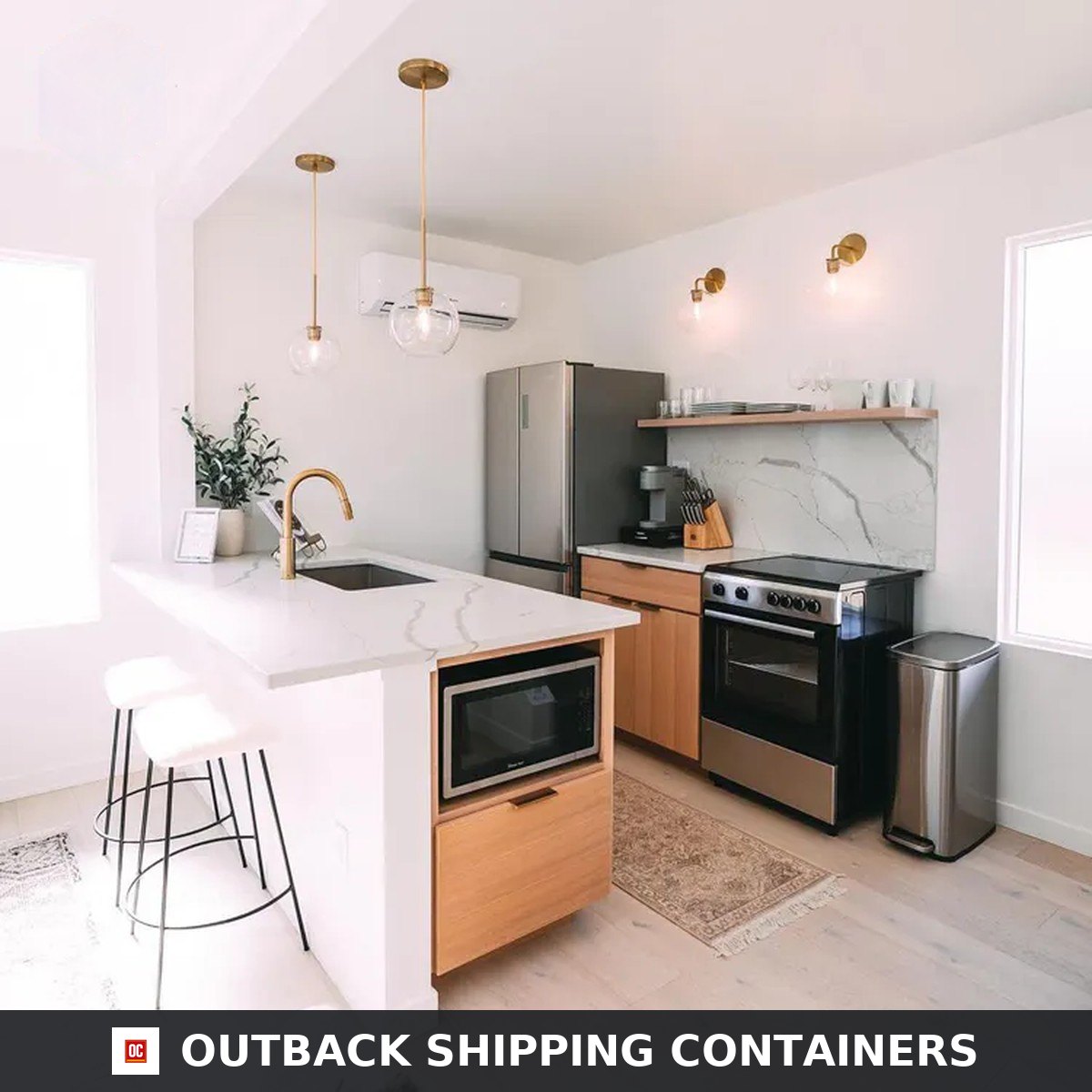 White oak kitchen inside the Duplex 3BHK container home with quartz waterfall island, breakfast stools and stainless appliances