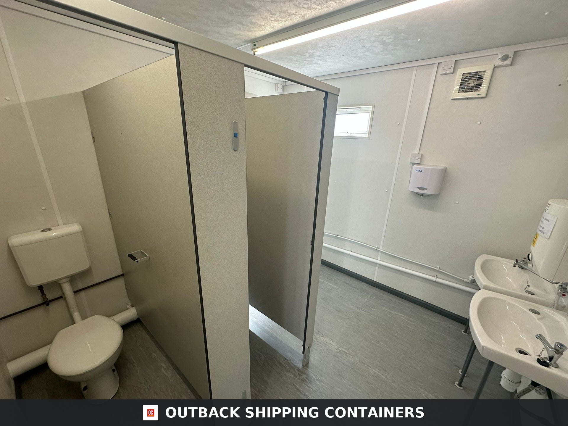 32 x 10Ft 32x10FT for Sale — Door and Entry Detail | Outback Shipping Containers Refurbished office cabin toilet block interior showing white stalls toilet and double sink basins with soap dispenser