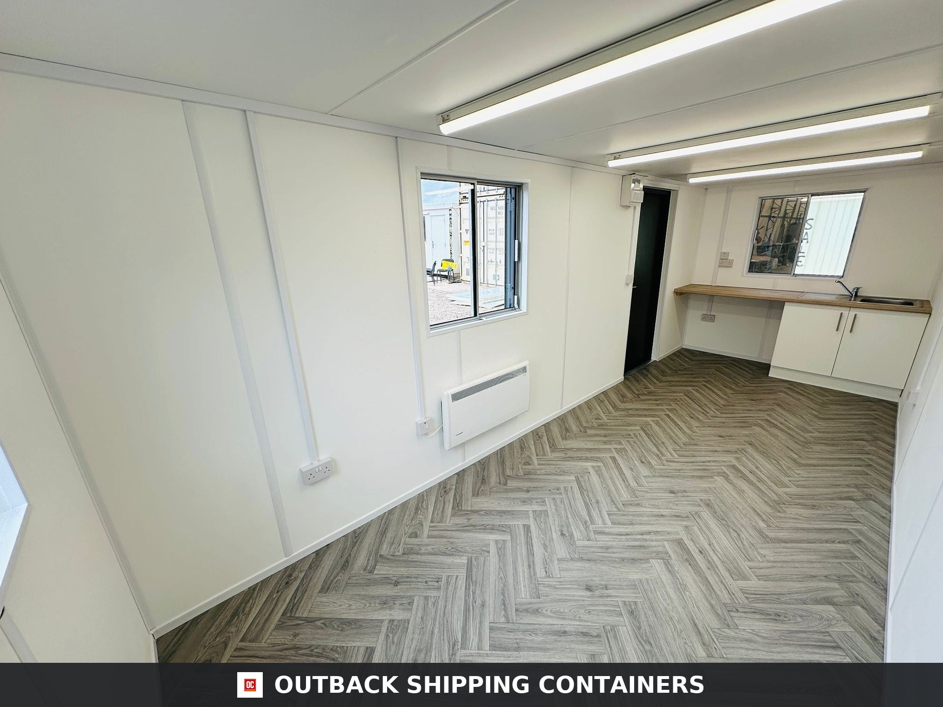 21x8ft for Sale — Door and Entry Detail | Outback Shipping Containers 21ft anti-vandal office container with gray steel exterior, heavy-duty window shutters, and personal entry door
