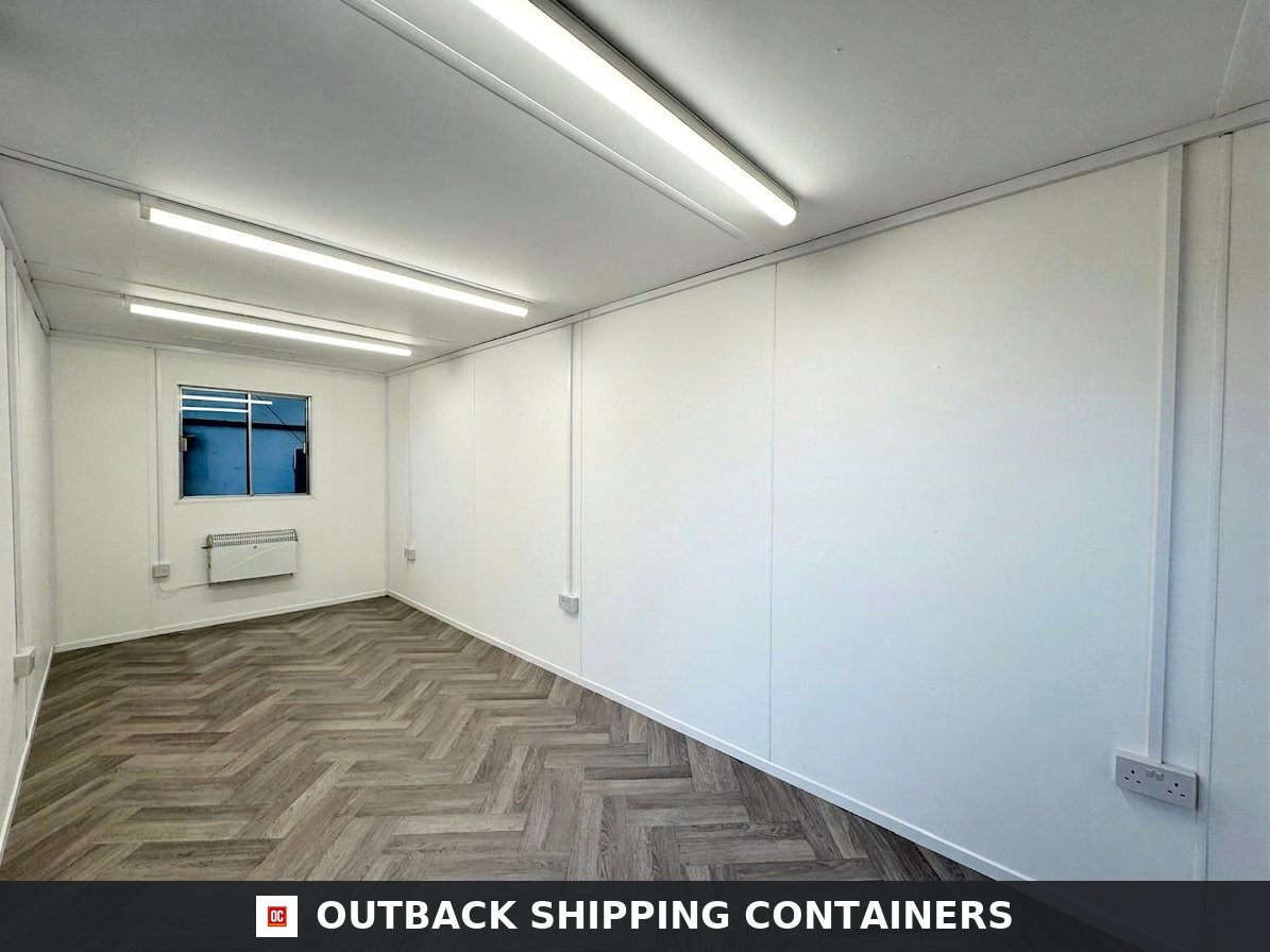 20x8ft for Sale — Side Profile View | Outback Shipping Containers Refurbished 20x8 gray metal portable office container with single steel door and external electrical connection
