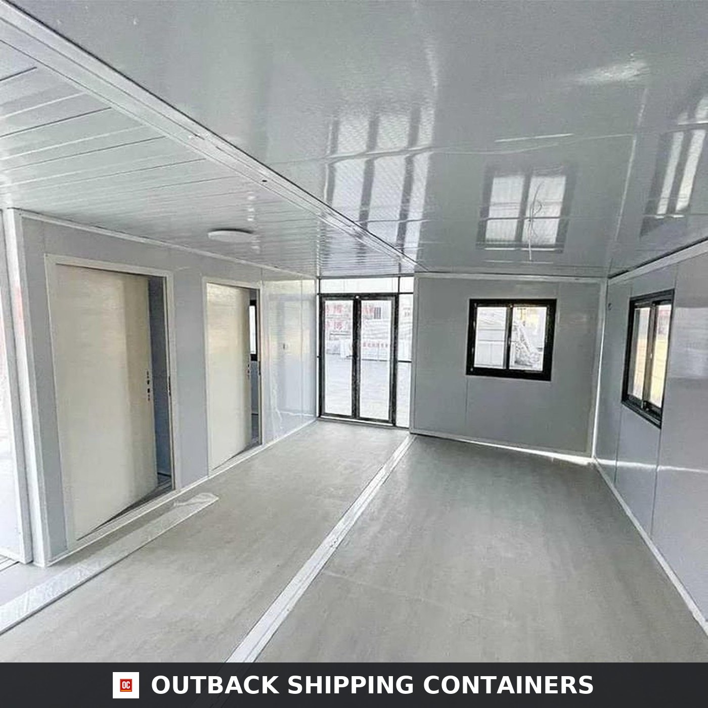 40ft Luxury 3 Bedroom Foldable Container Home for Sale — Glazed Interior Shell | Outback Shipping Containers Interior shell of the 40ft expandable container home showing the glazed end wall, sliding bedroom doors and insulated ceiling