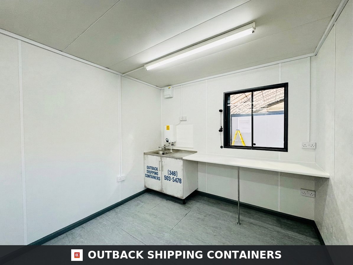 32x10ft for Sale — Side Profile View | Outback Shipping Containers Refurbished 32x10ft container changing room interior with white walls, a sink vanity, and long work counter