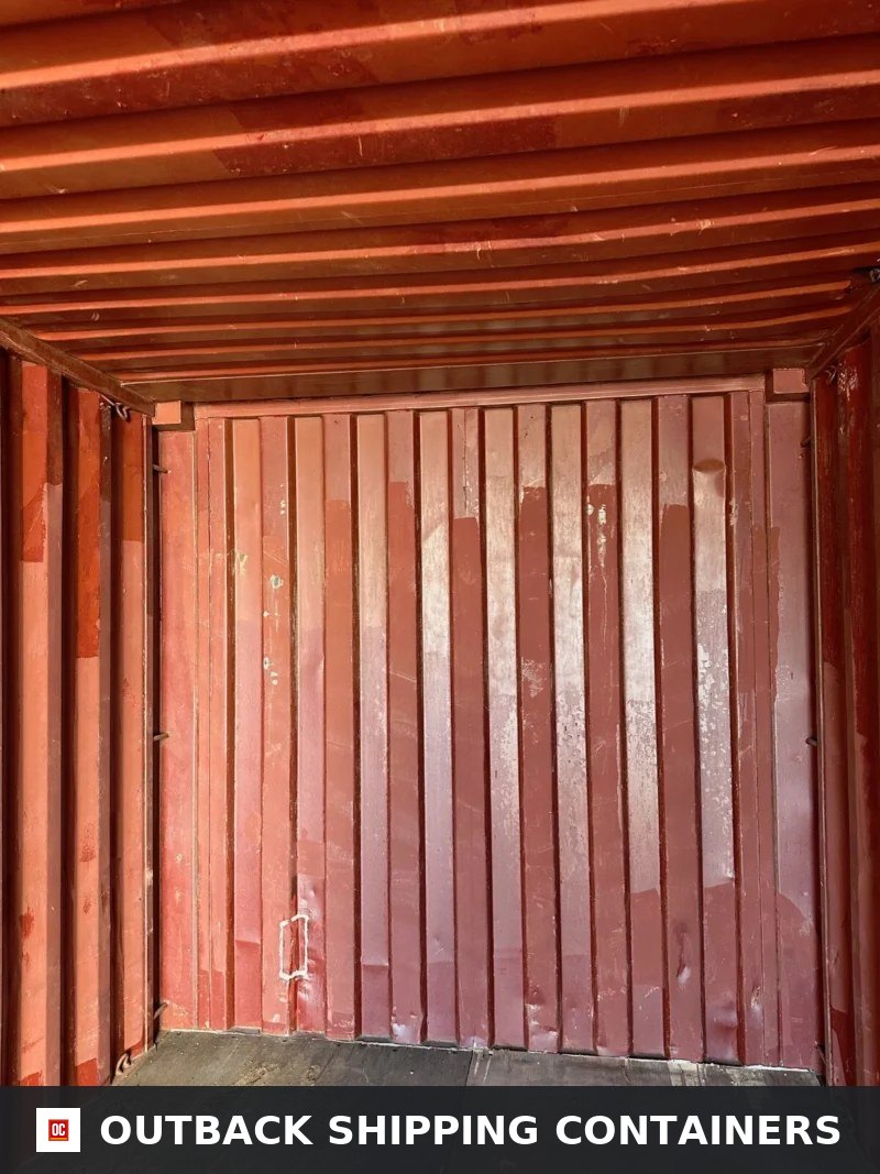 Used 20ft Conex Shipping / Storage Container — Interior Detail | Outback Shipping Containers Interior view of a 20ft conex container showing the red-painted steel back wall and ceiling rafters