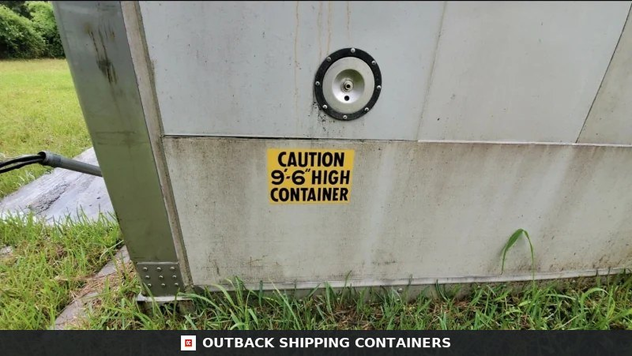 Stoughton Shipping Container (40ft) Close up of a 40ft Stoughton shipping container with a yellow 9 foot 6 inch high caution decal on a metal panel