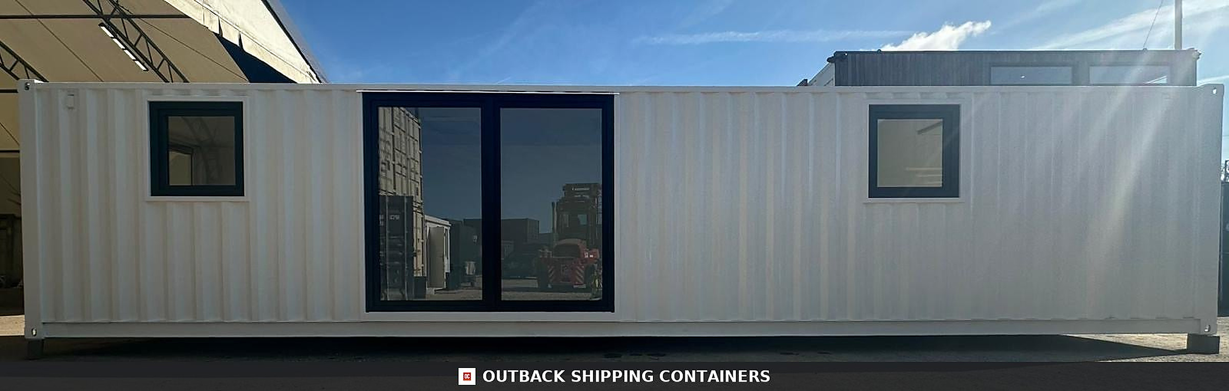 40ft white shipping container office conversion with central glass double doors and two small black framed windows