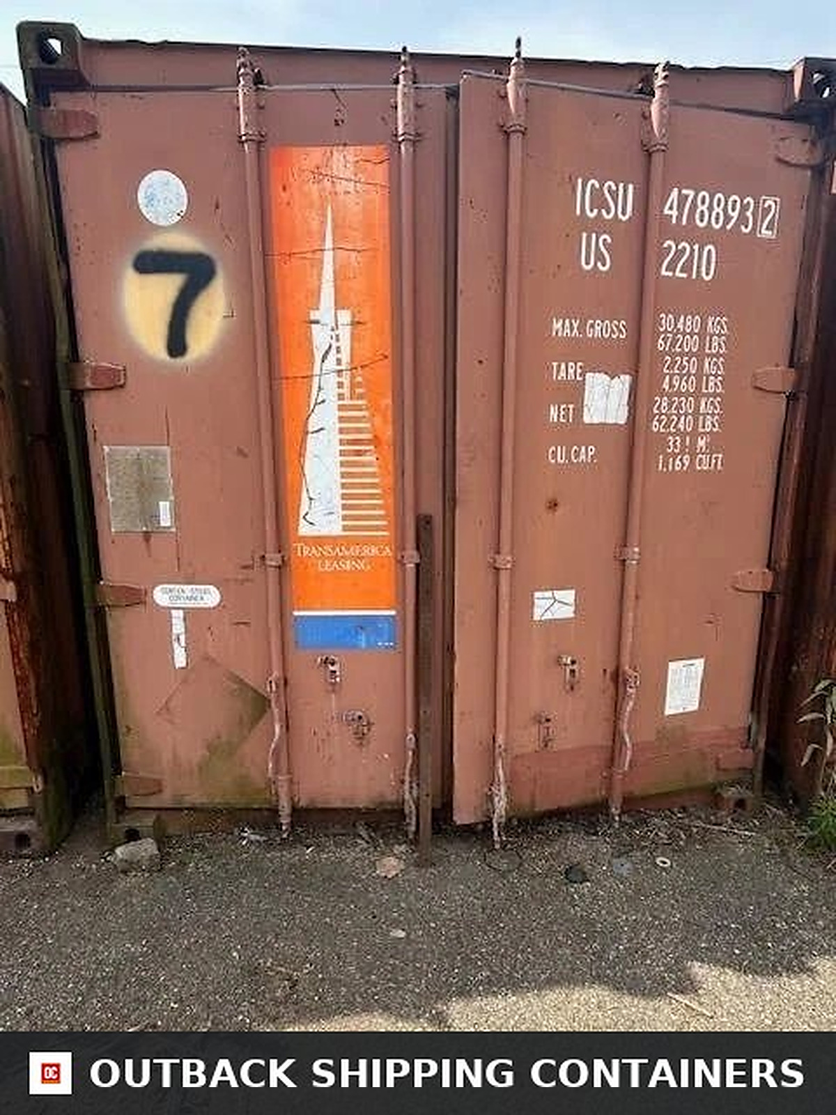 Cargo doors of a used 20 foot brown storage container with vertical locking bars and original identification markings