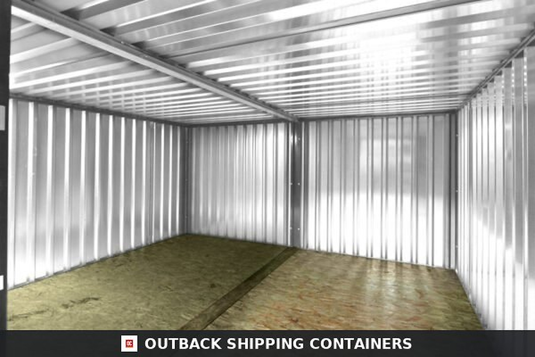 Interior view of side-linked galvanized flat pack containers showing corrugated steel walls and OSB flooring