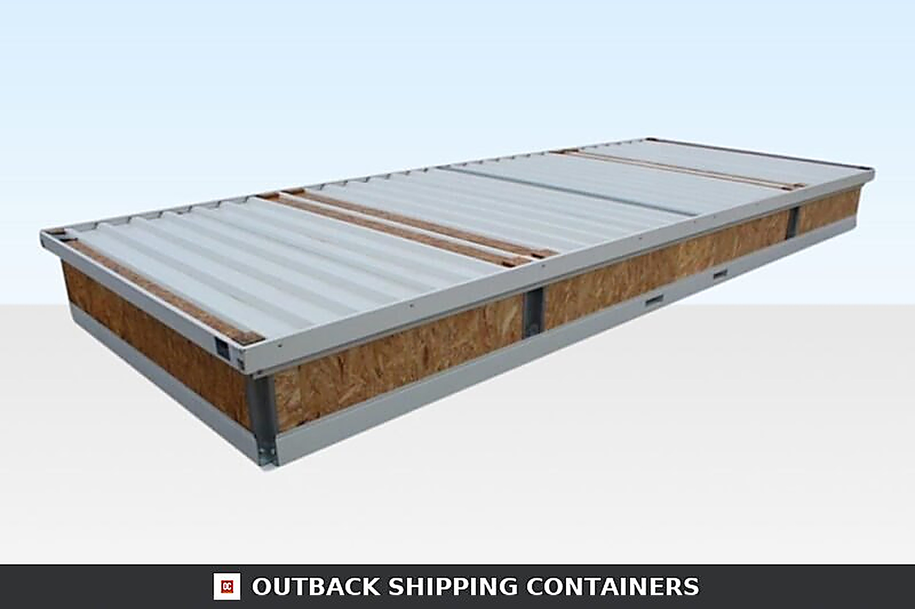 Collapsed large flat pack office unit showing folded steel roof panels and OSB wood siding in a bundled state
