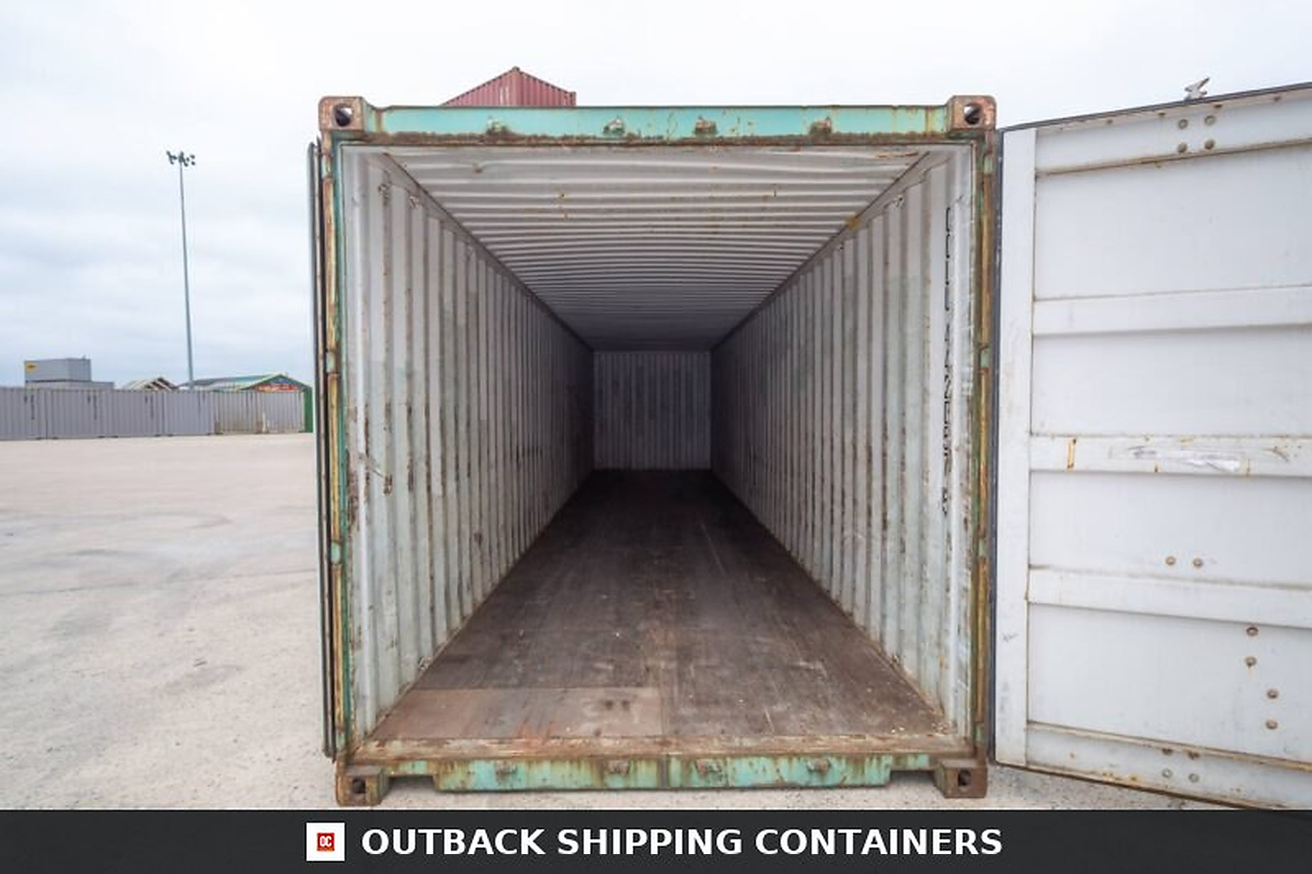 Interior view of an open 40ft preloved shipping container showing marine grade plywood floors and steel walls