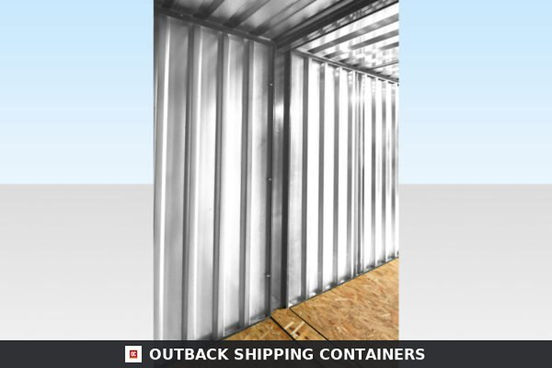 Interior view of an end-linked flat packed container showing galvanized steel walls and particle board flooring