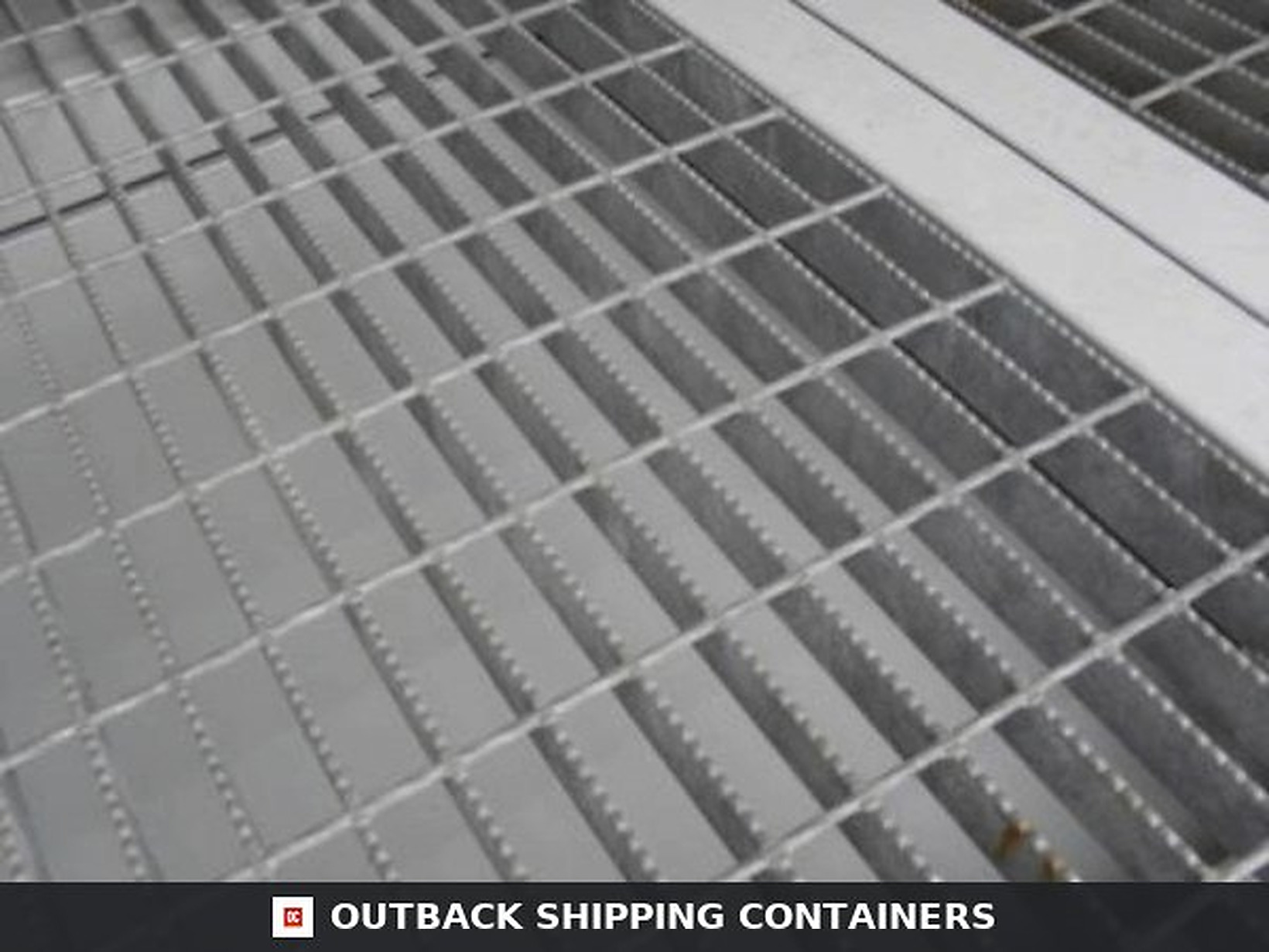 20Ft X 8Ft Open Side Bunded Open Mesh Floor Store for Sale — Side Profile View Open mesh floor of a bunded storage container showing galvanized steel grating with serrated edges for traction