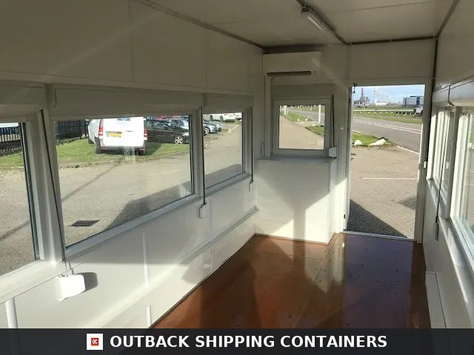 Interior view of 20ft high cube observation container with fixed glazing windows and white paneled walls