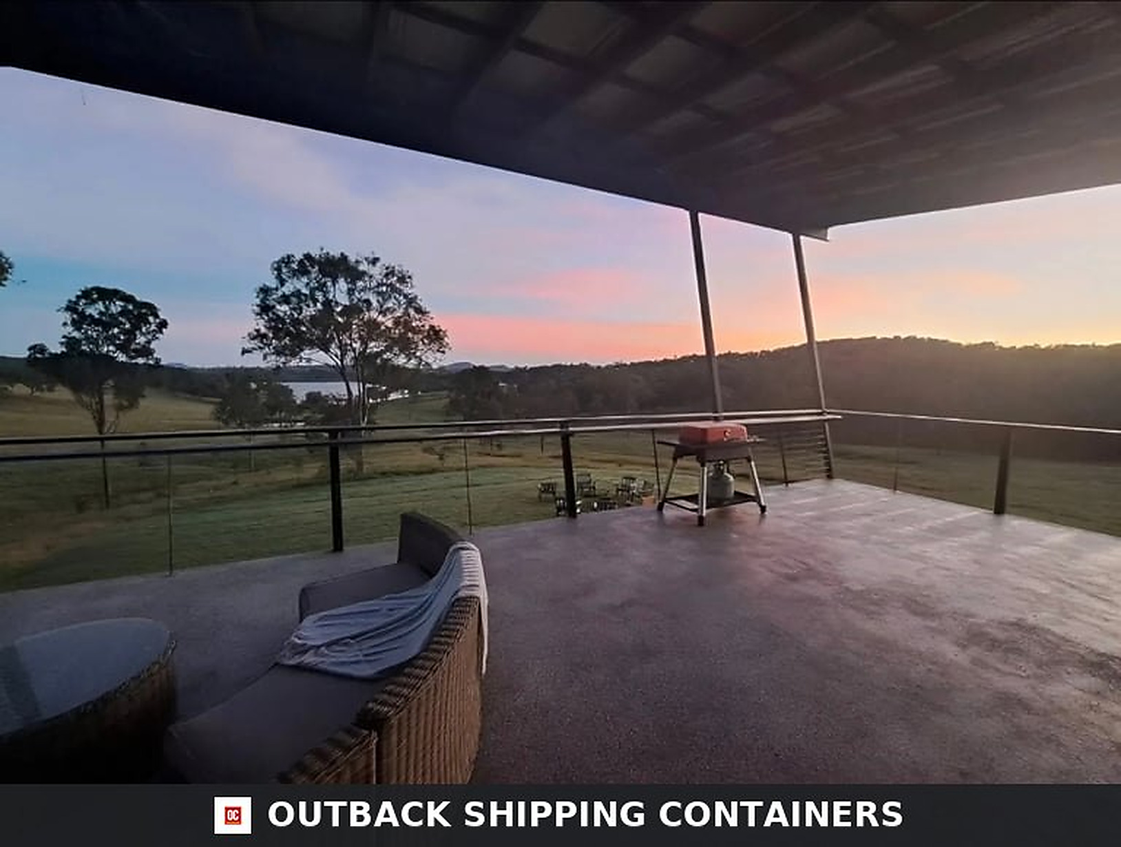 Rooftop terrace of the 3BHK container home at sunset with lounge seating and panoramic valley views
