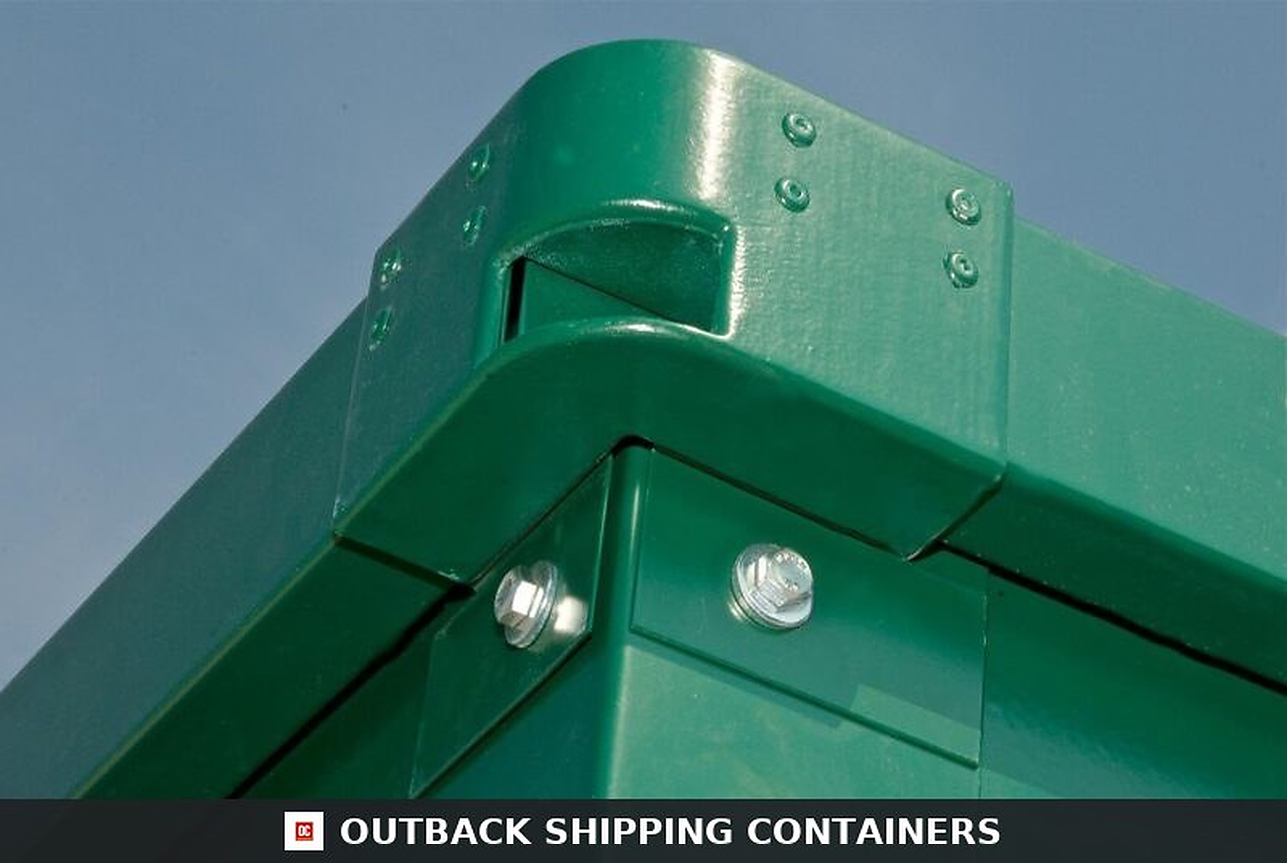 Close-up of a green flat pack office container corner joint with heavy duty bolts and rounded edge