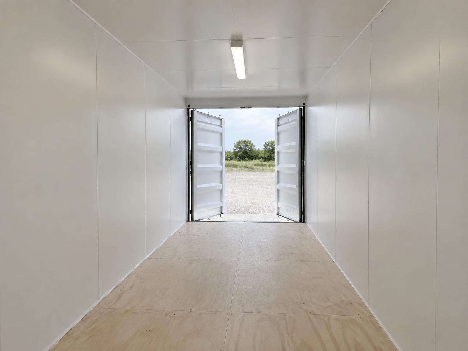 Insulated & Finished Container (No Windows) — Finished Interior Insulated and finished shipping container interior — painted wall and ceiling panels over a framed lining, no windows (representative image)