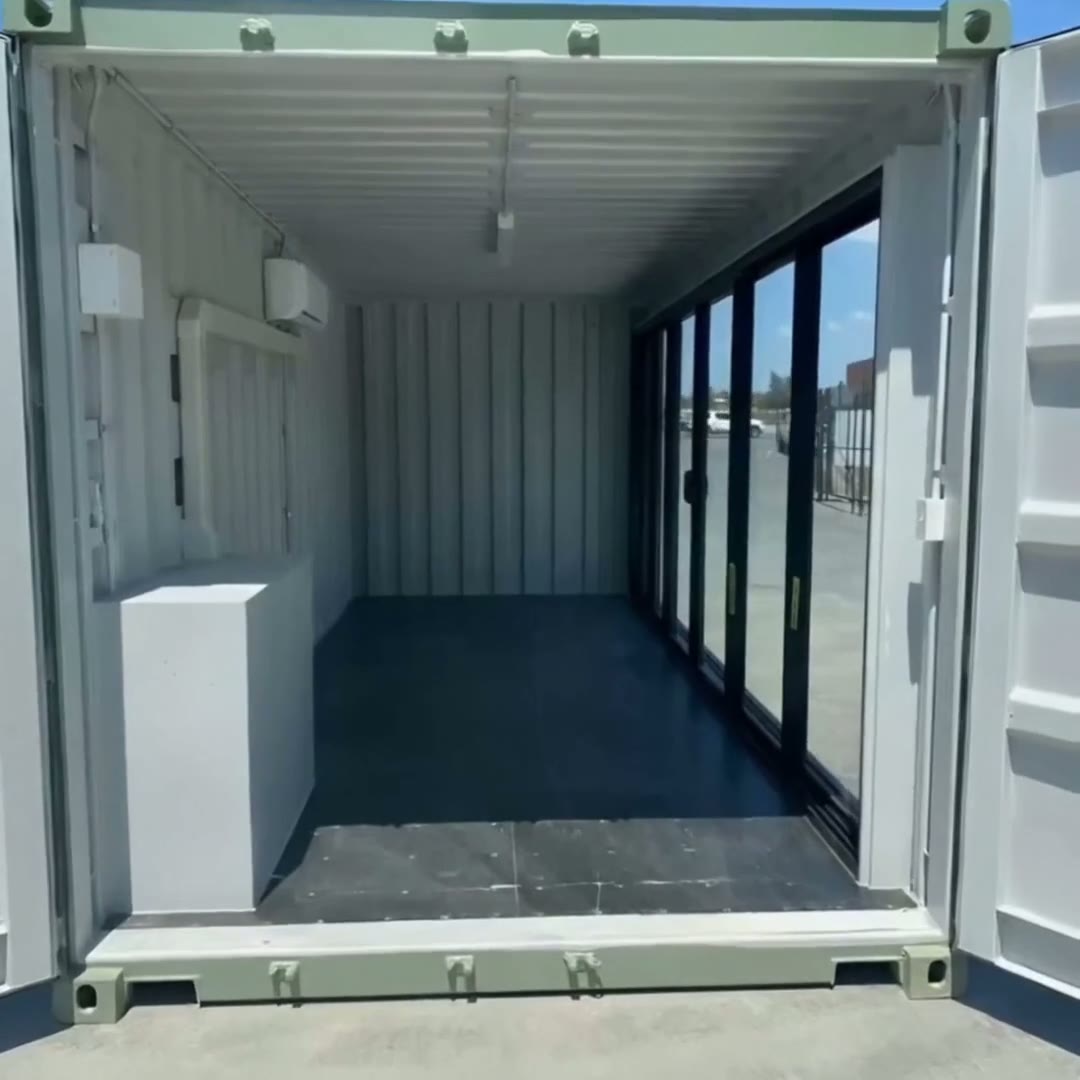Modified 20ft container office with full-height glass sliding door, wall-mounted AC and finished white interior