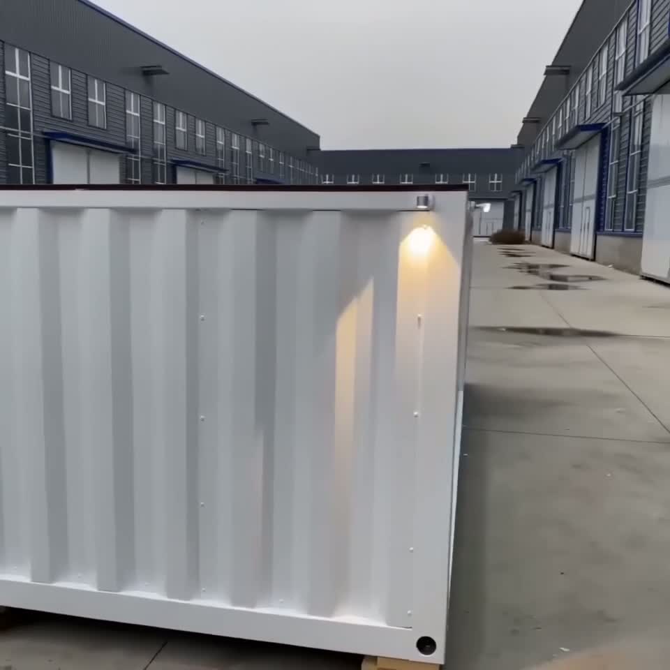 Exterior of a white 20ft shipping container pool with outdoor lighting at a warehouse facility