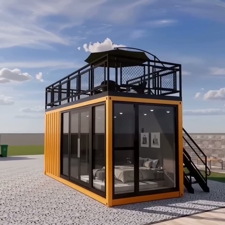 Exterior view of a yellow 20ft prefab shipping container home with a glass front, side stairs, and a rooftop deck